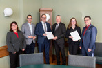 Fachamtsleiterin Manuela Kehrer, Beigeordneter Mario Müller, Digitalminister Dirk Panter, Landrat Carsten Michaelis, Dezernentin Annegret von Lindeman und Steffen Lehmann, Referatsleiter im Digitalministerium (v. l.). bei der Übergabe der Bescheide